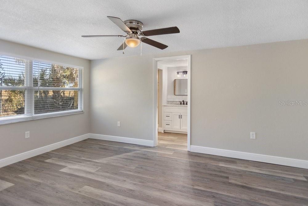 7605 Fox Hollow Drive Port Richey, FL 34668 - Photo 17 of 29 a view of an empty room with a window and wooden floor