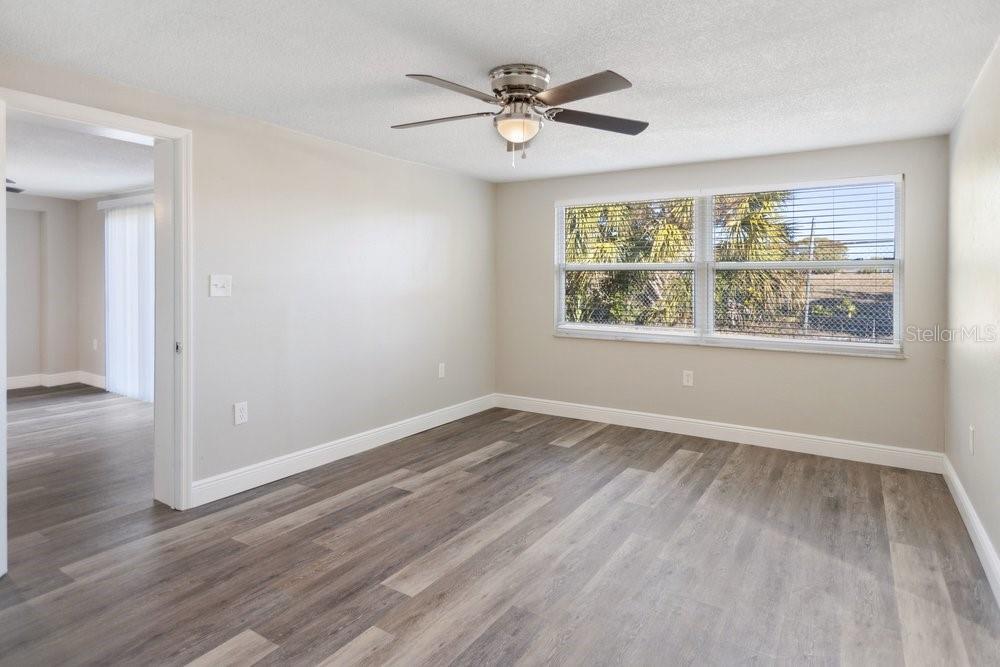 7605 Fox Hollow Drive Port Richey, FL 34668 - Photo 19 of 29 a view of an empty room with wooden floor and a window