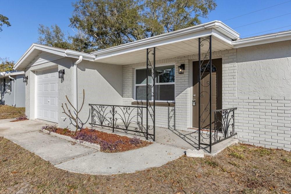 7605 Fox Hollow Drive Port Richey, FL 34668 - Photo 27 of 29 a view of a house with a porch