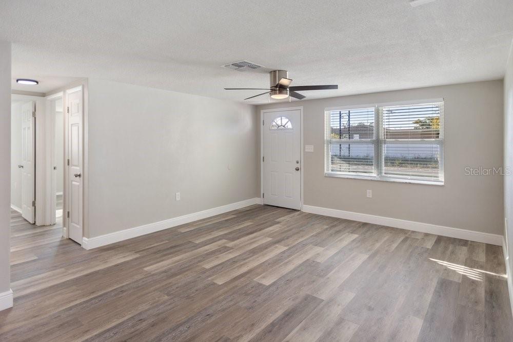 7605 Fox Hollow Drive Port Richey, FL 34668 - Photo 3 of 29 wooden floor in an empty room with a window