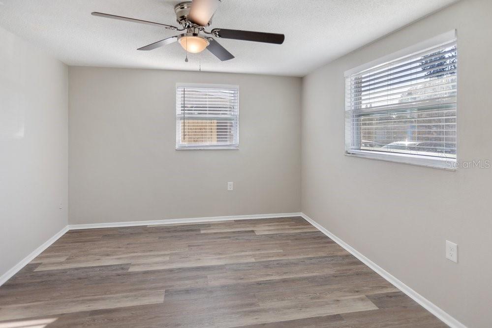 7605 Fox Hollow Drive Port Richey, FL 34668 - Photo 10 of 29 a view of an empty room with window and chandelier fan
