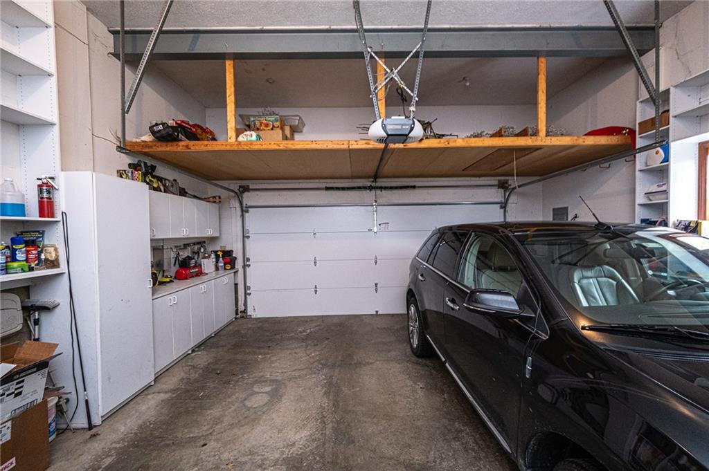 630 Hemlock Road Coraopolis, PA 15108 - Photo 21 of 25 Tons of storage in this 2 car attached garage with built in shelving on both sides, a work bench and large overhead storage area.