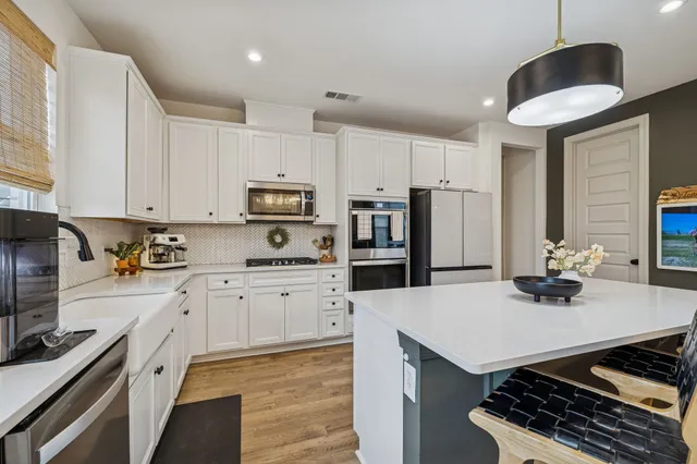 a kitchen with sink stove and refrigerator