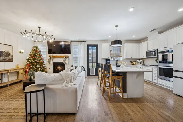 a open kitchen with white cabinets and stainless steel appliances