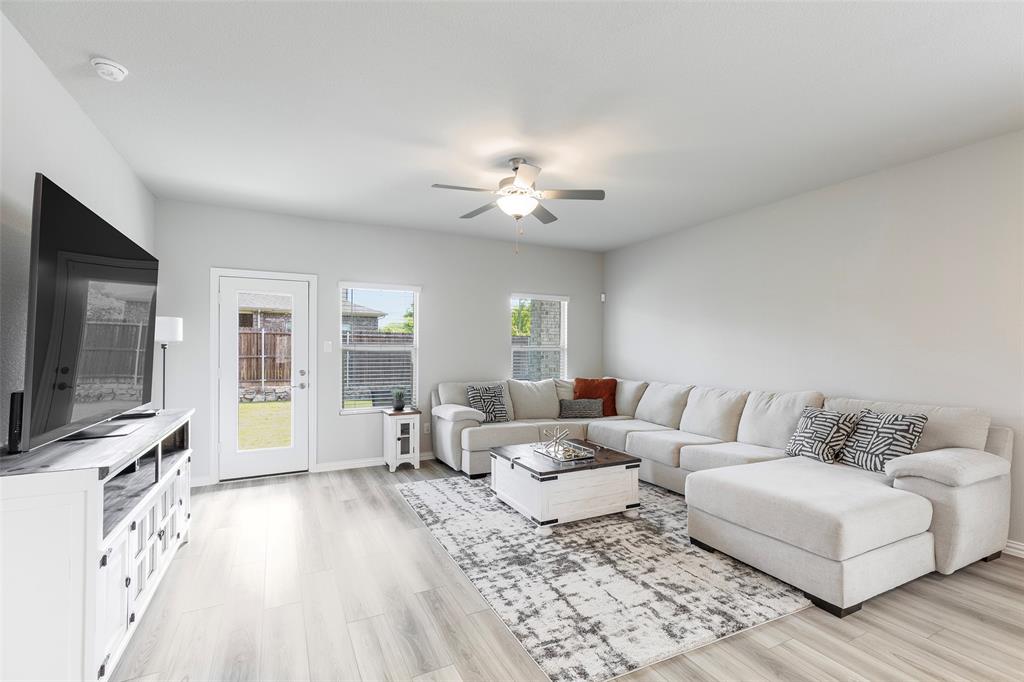 1504 Cobblestone Road Melissa, TX 75454 - Photo 12 of 40 Light-filled family room with access to the large backyard with a covered patio.