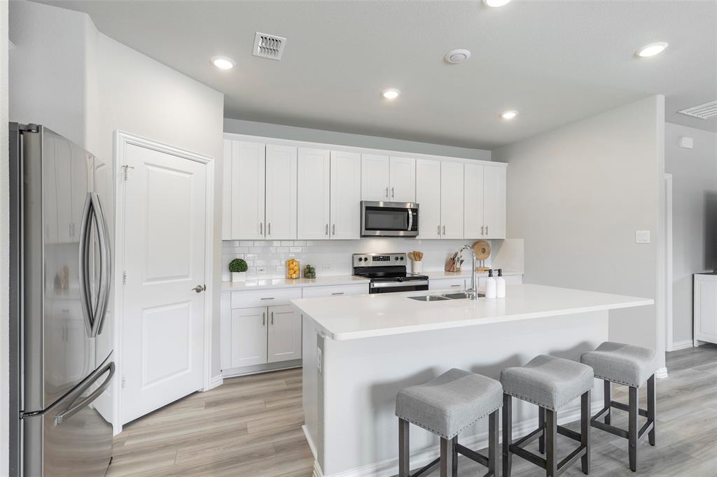 1504 Cobblestone Road Melissa, TX 75454 - Photo 4 of 40 sland kitchen designed for connection and flow with stainless steel appliances.