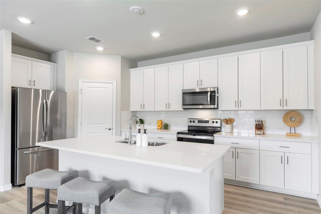 1504 Cobblestone Road Melissa, TX 75454 - Photo 5 of 40 Bright culinary space with extended cabinetry and prep surfaces easy for entertaining.