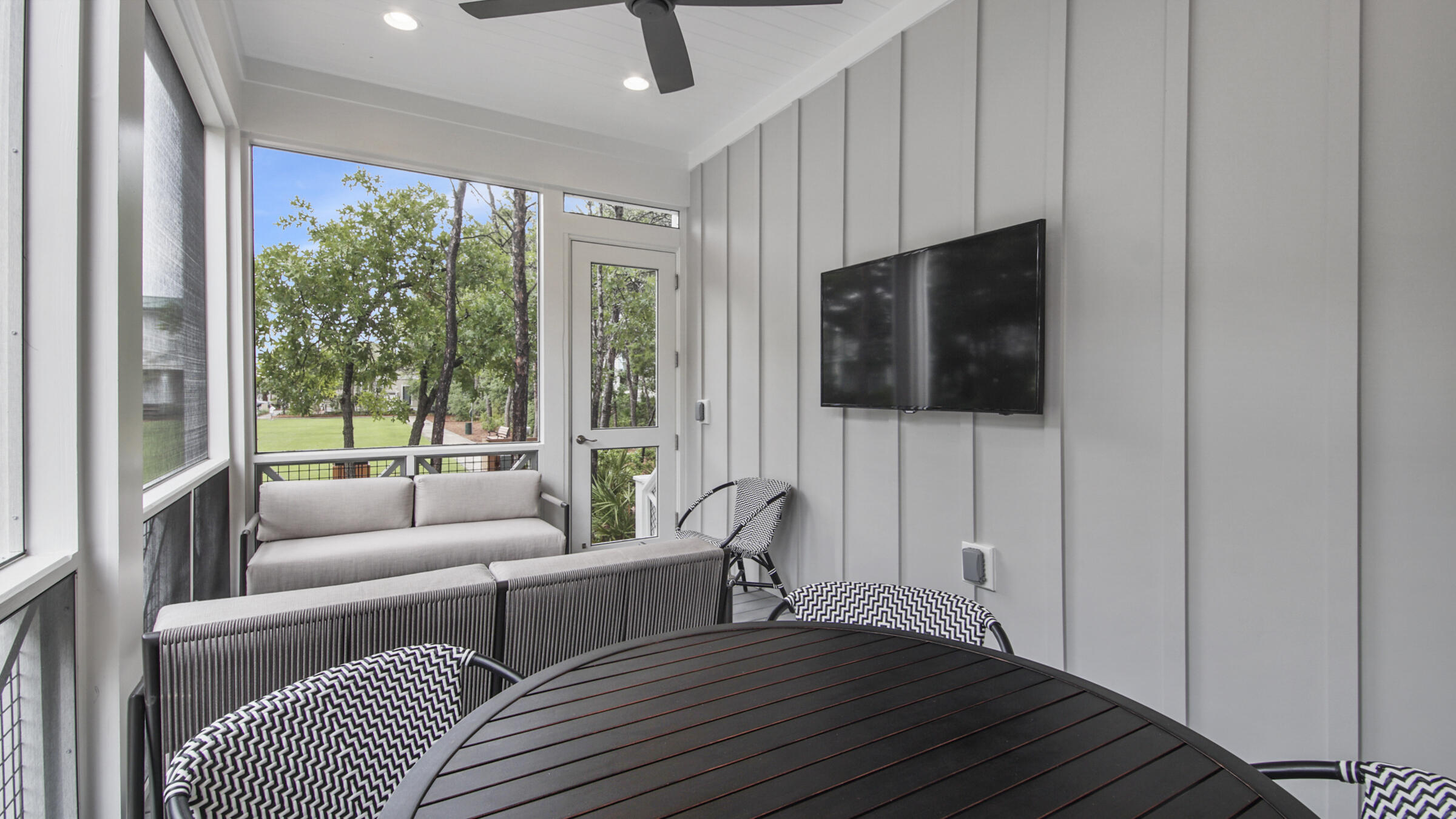 39 Beach Bike Way Inlet Beach Inlet Beach, FL 32461 - Photo 10 of 47 a living room with furniture a flat screen tv and a floor to ceiling window
