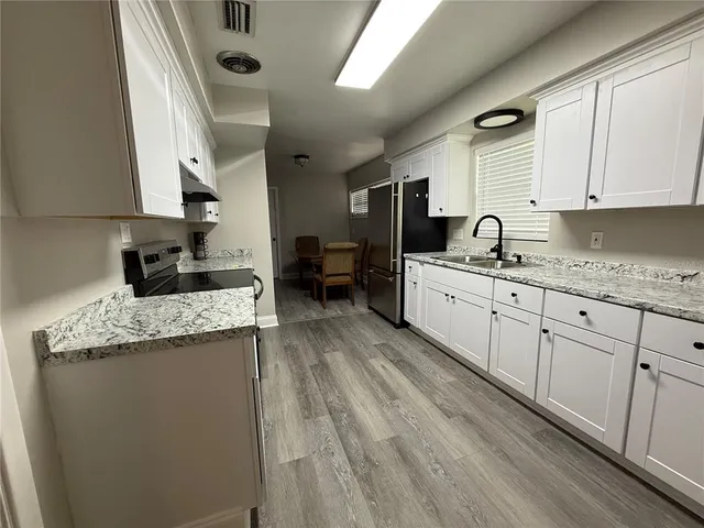 a dining room with furniture and wooden floor