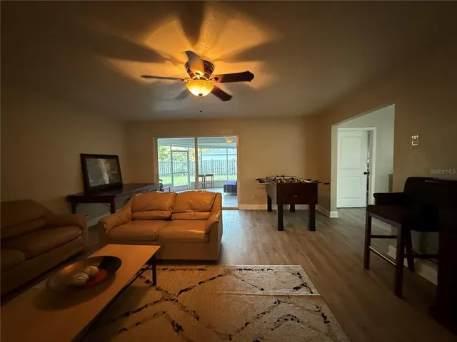a living room with furniture and a floor to ceiling window