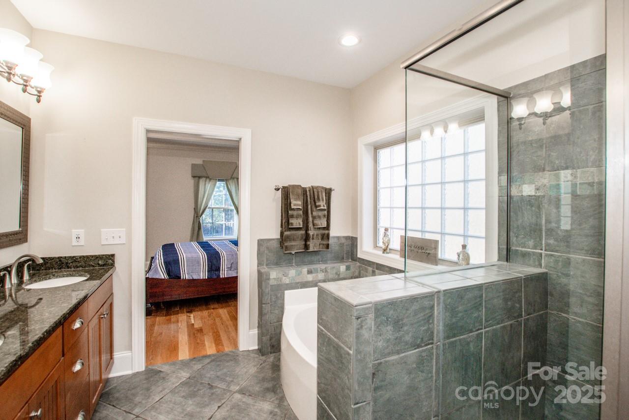 570 Morrison Farm Road Troutman, NC 28166 - Photo 17 of 32 a kitchen with kitchen island granite countertop a sink stove and cabinets