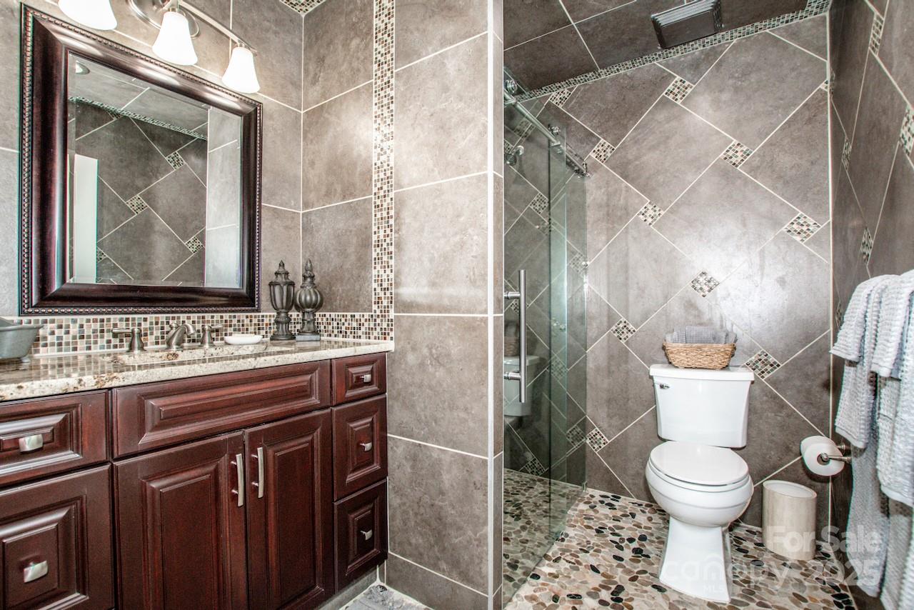 570 Morrison Farm Road Troutman, NC 28166 - Photo 21 of 32 a bathroom with a toilet sink and mirror