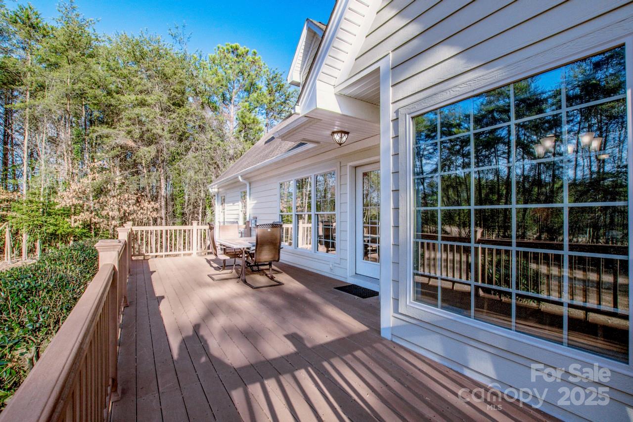 570 Morrison Farm Road Troutman, NC 28166 - Photo 30 of 32 a view of a balcony with wooden floor and bench