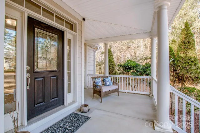 a view of a porch with wooden floor and furniture