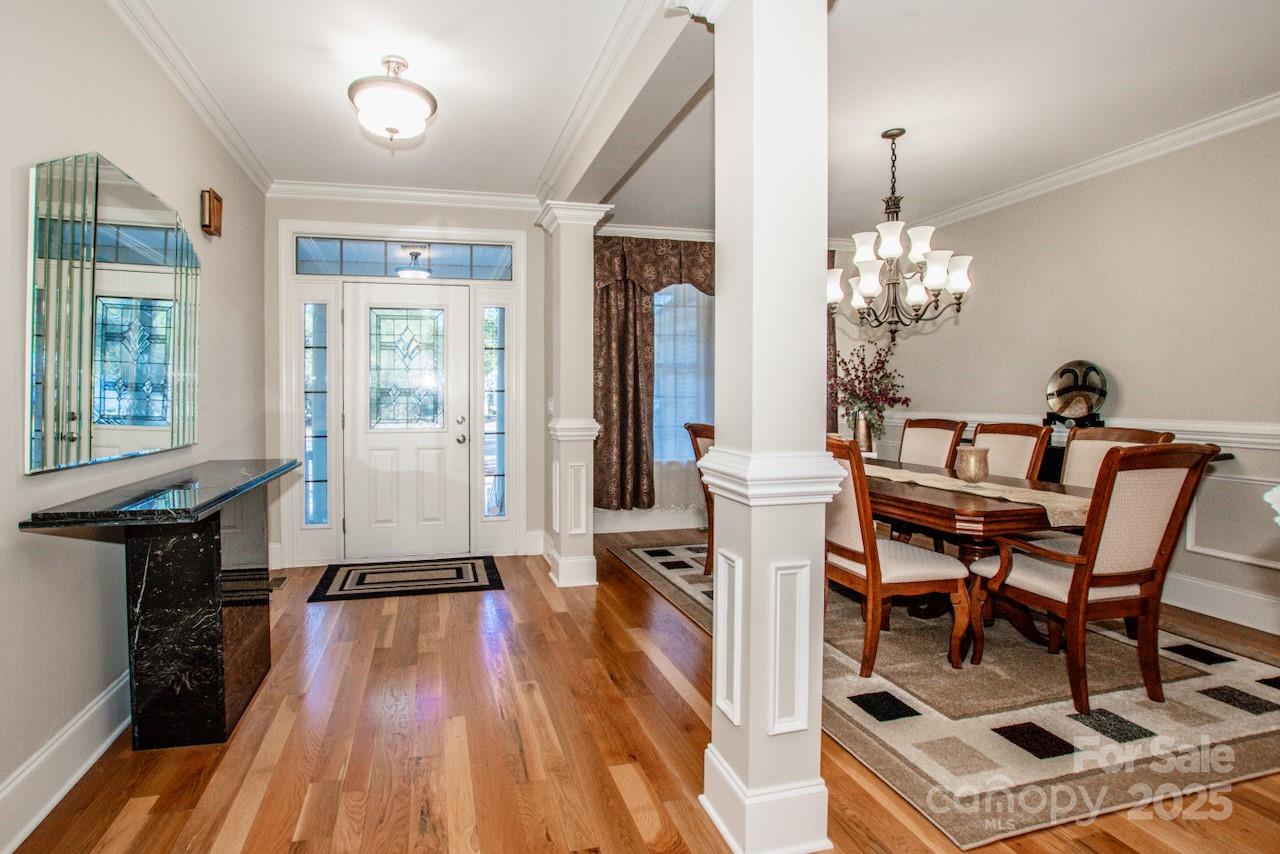 570 Morrison Farm Road Troutman, NC 28166 - Photo 4 of 32 a dining room with furniture a chandelier and wooden floor