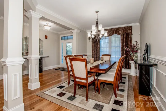a dining room with furniture and wooden floor
