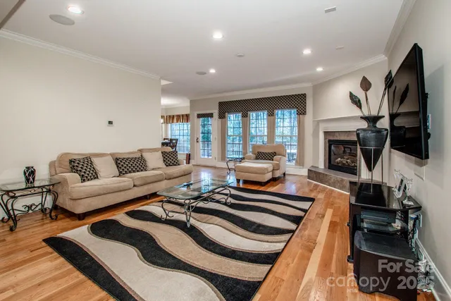 a living room with furniture fireplace and flat screen tv