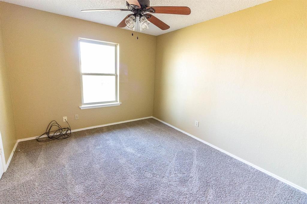 1007 Phillips Circle Kaufman, TX 75142 - Photo 11 of 12 an empty room with a window and a fan