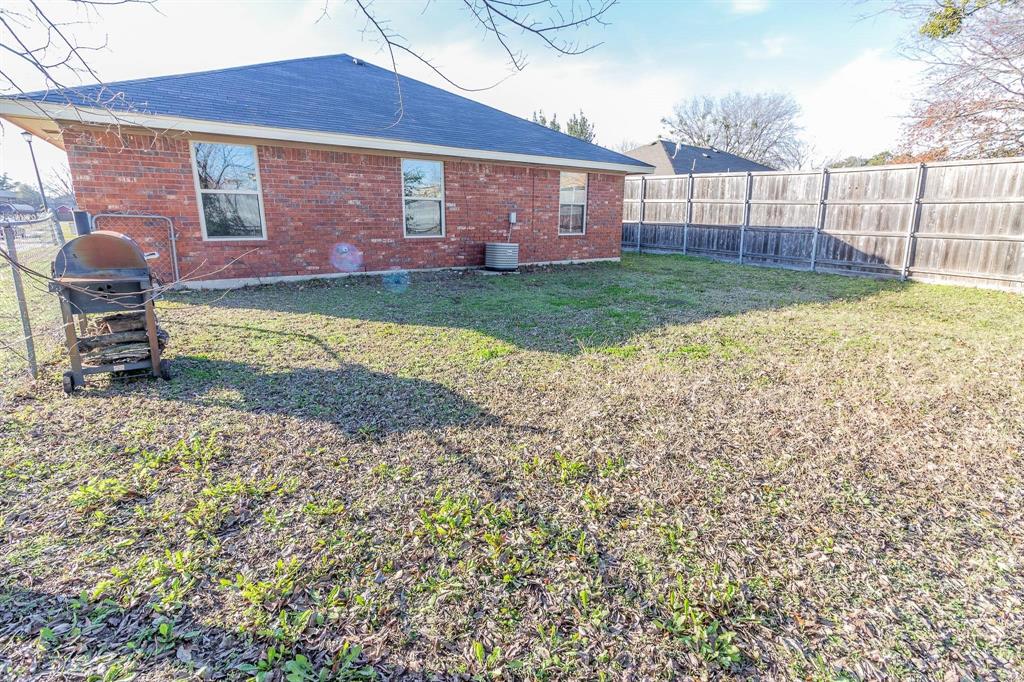1007 Phillips Circle Kaufman, TX 75142 - Photo 12 of 12 a view of a backyard with a garden and plants