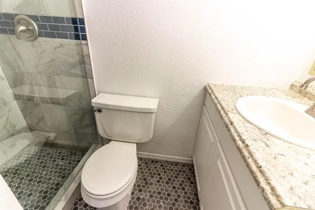 a bathroom with a toilet and a shower