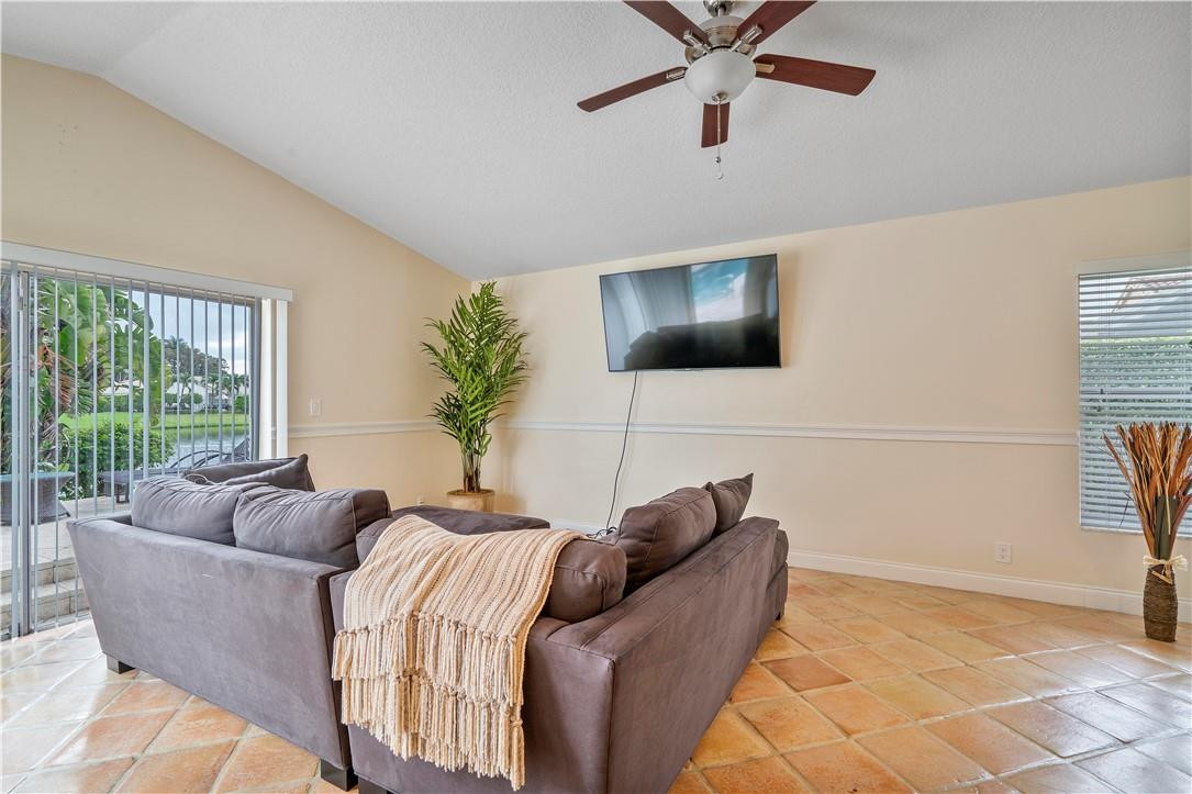 9695 West Lake Court Boca Raton, FL 33434 - Photo 11 of 43 a living room with furniture and a flat screen tv