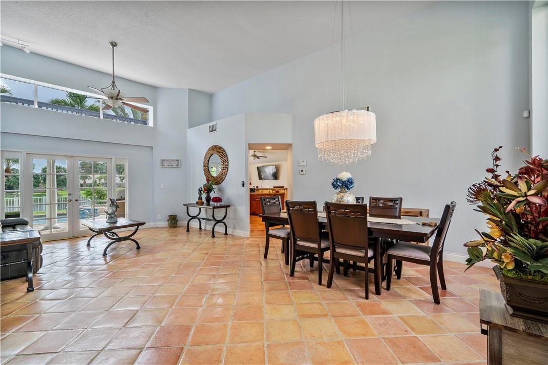 9695 West Lake Court Boca Raton, FL 33434 - Photo 13 of 43 a view of a dining room with furniture and chandelier