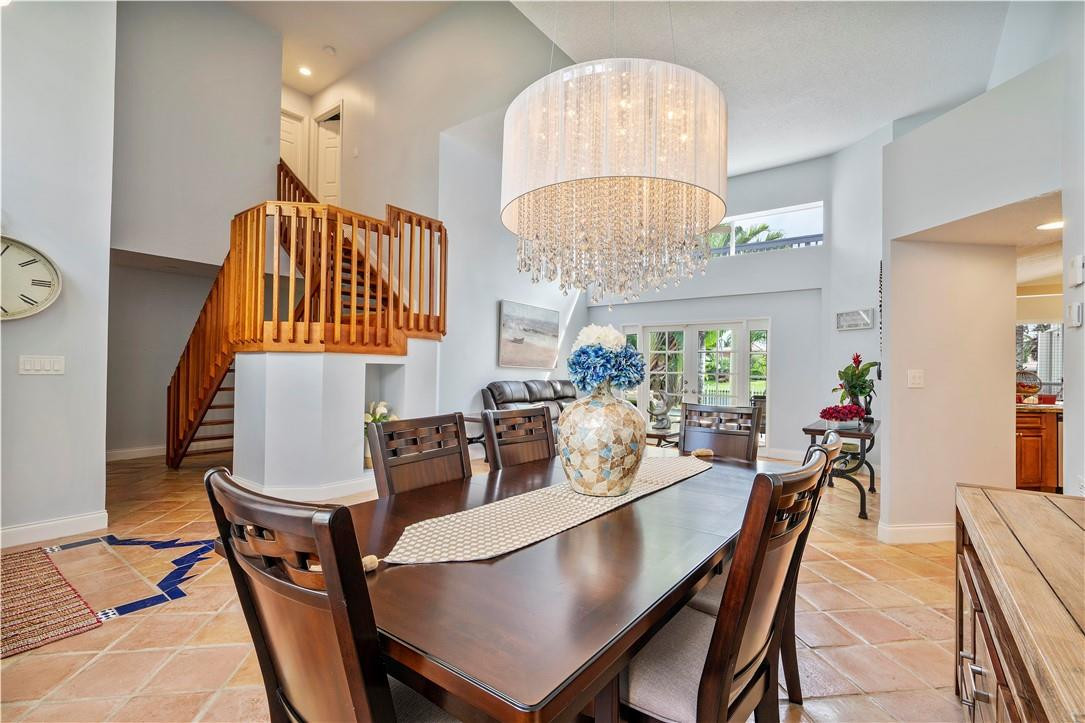 9695 West Lake Court Boca Raton, FL 33434 - Photo 14 of 43 a view of a dining room with furniture and chandelier