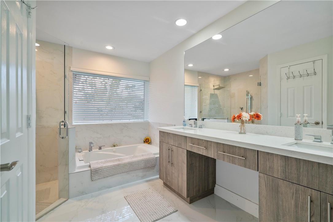 9695 West Lake Court Boca Raton, FL 33434 - Photo 21 of 43 a spacious bathroom with a tub sink shower and mirror