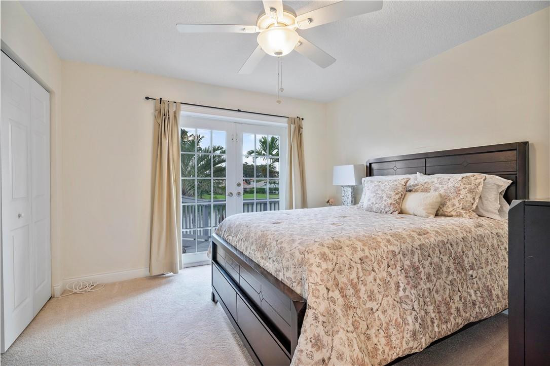 9695 West Lake Court Boca Raton, FL 33434 - Photo 23 of 43 a bed sitting in a bedroom next to a window