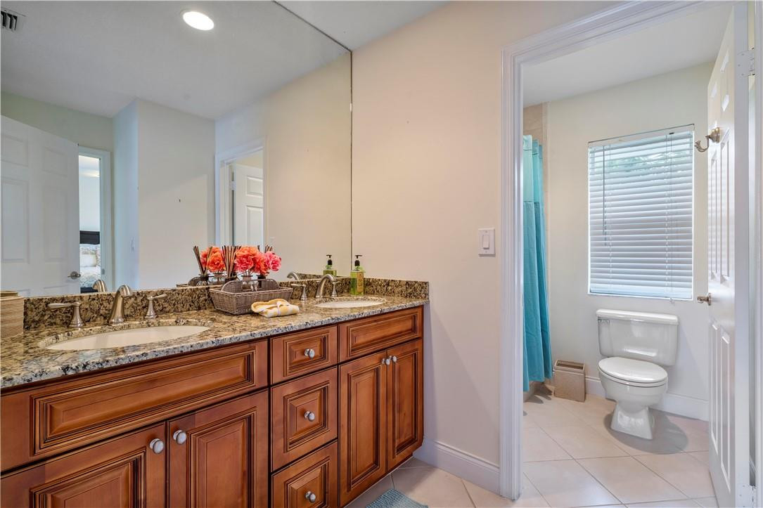9695 West Lake Court Boca Raton, FL 33434 - Photo 26 of 43 a bathroom with a granite countertop sink and a mirror