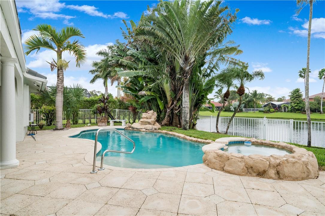 9695 West Lake Court Boca Raton, FL 33434 - Photo 27 of 43 a view of a swimming pool with a lounge chair