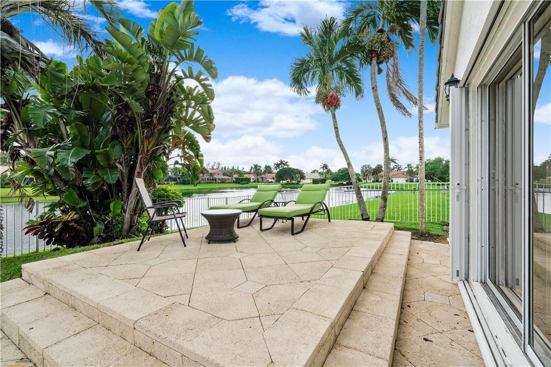 9695 West Lake Court Boca Raton, FL 33434 - Photo 29 of 43 a view of a park with couches and wooden fence