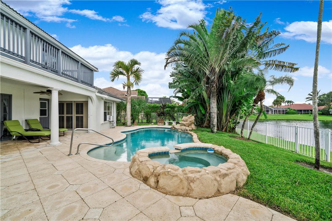 9695 West Lake Court Boca Raton, FL 33434 - Photo 30 of 43 a view of a house with backyard sitting area and swimming pool