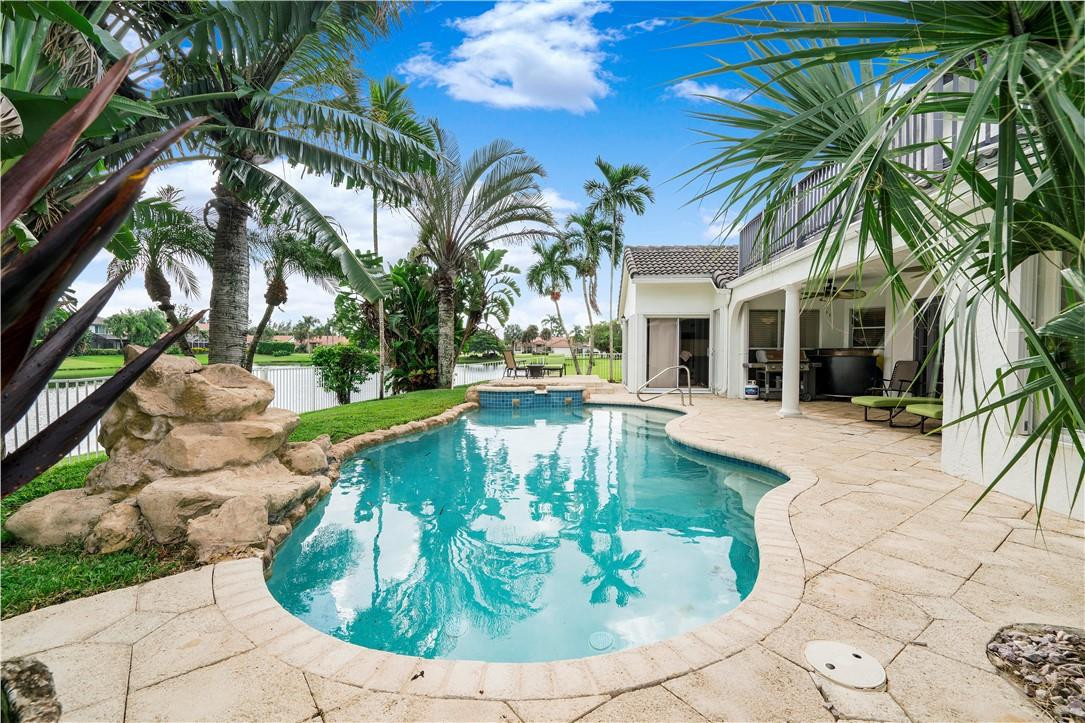 9695 West Lake Court Boca Raton, FL 33434 - Photo 33 of 43 a view of a swimming pool with a patio
