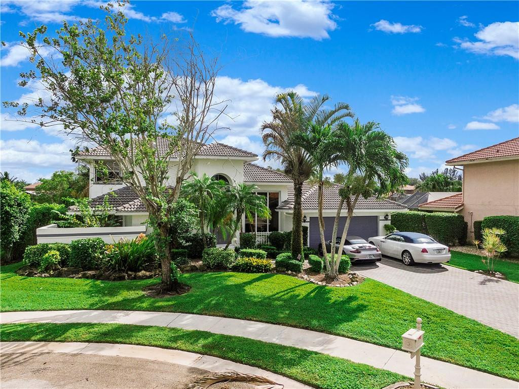 9695 West Lake Court Boca Raton, FL 33434 - Photo 36 of 43 a view of a backyard with a garden and plants