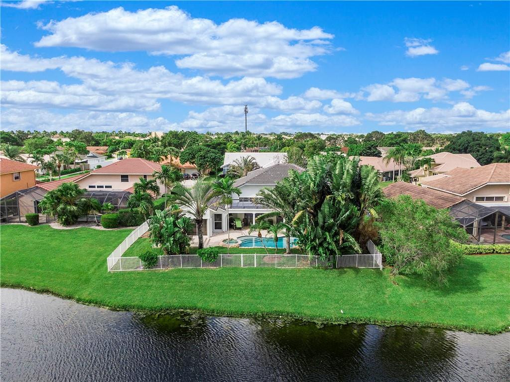 9695 West Lake Court Boca Raton, FL 33434 - Photo 4 of 43 front view of house with a yard