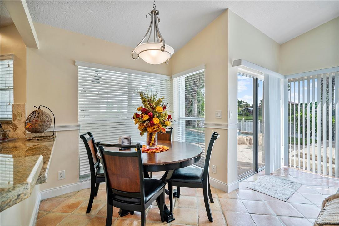 9695 West Lake Court Boca Raton, FL 33434 - Photo 10 of 43 a dining room with furniture and a potted plant