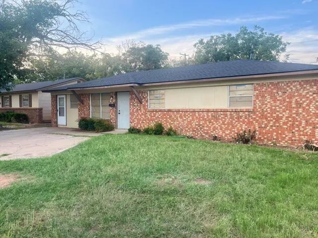 a view of house with backyard and garden