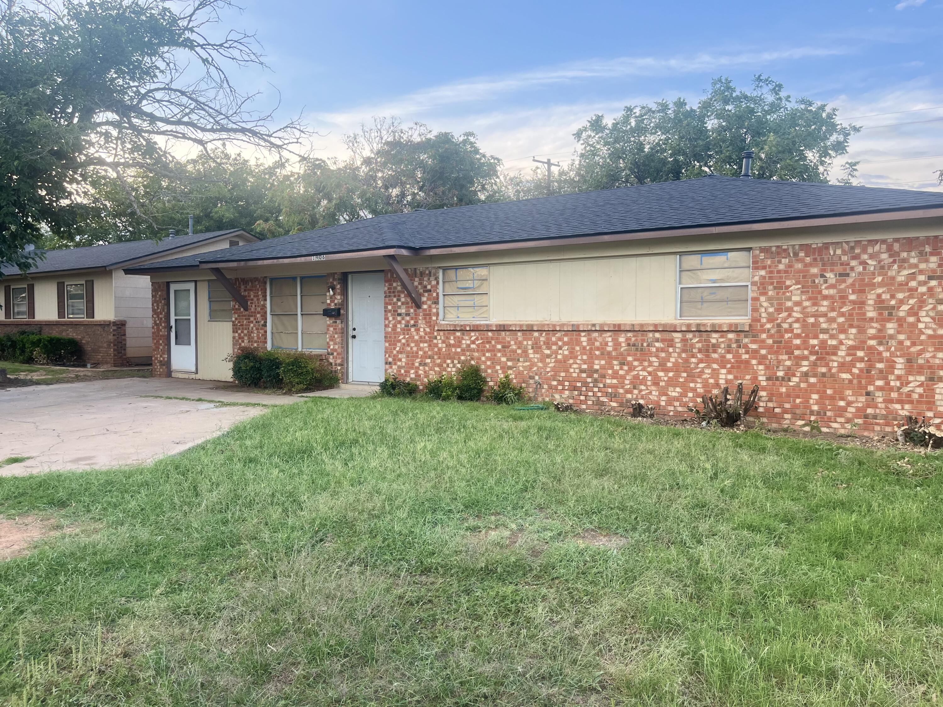 a view of house with backyard and garden