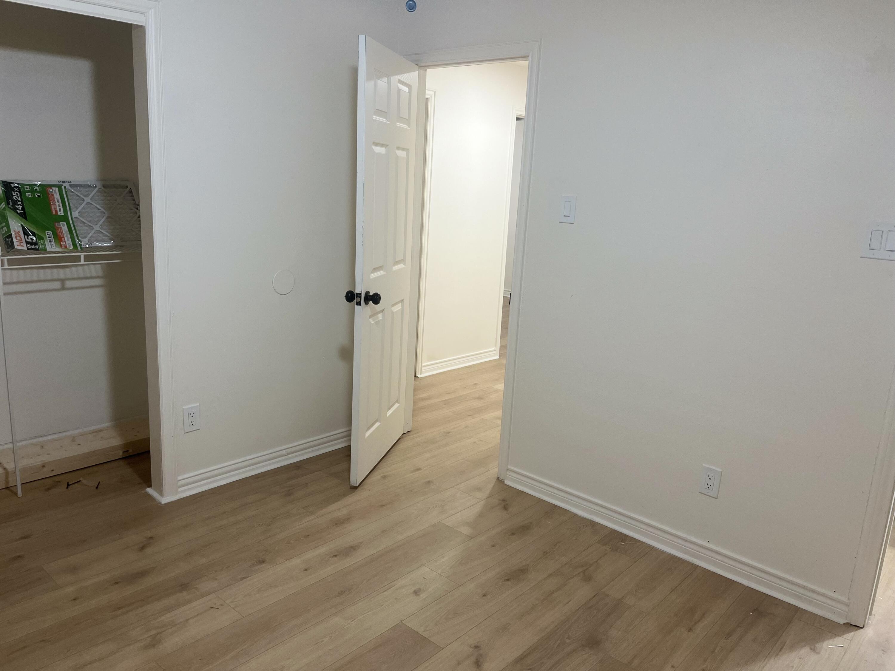 1906 70th Street Lubbock, TX 79412 - Photo 15 of 27 an empty room with wooden floor and windows