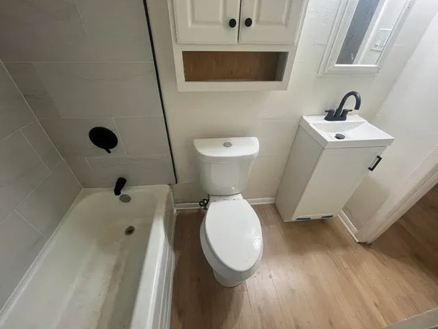 a bathroom with a toilet sink and mirror