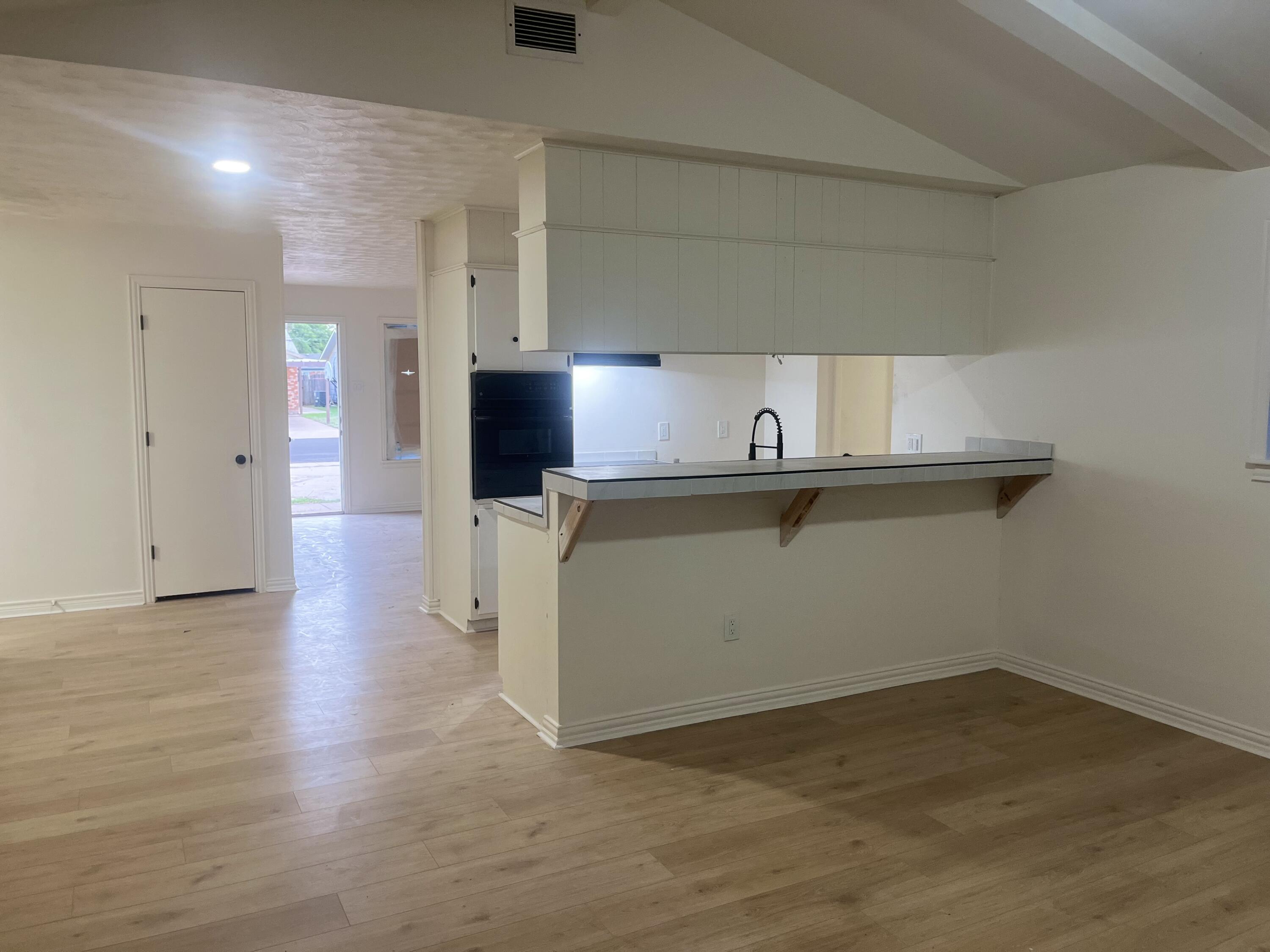 1906 70th Street Lubbock, TX 79412 - Photo 2 of 27 a view of a kitchen with a sink and dishwasher