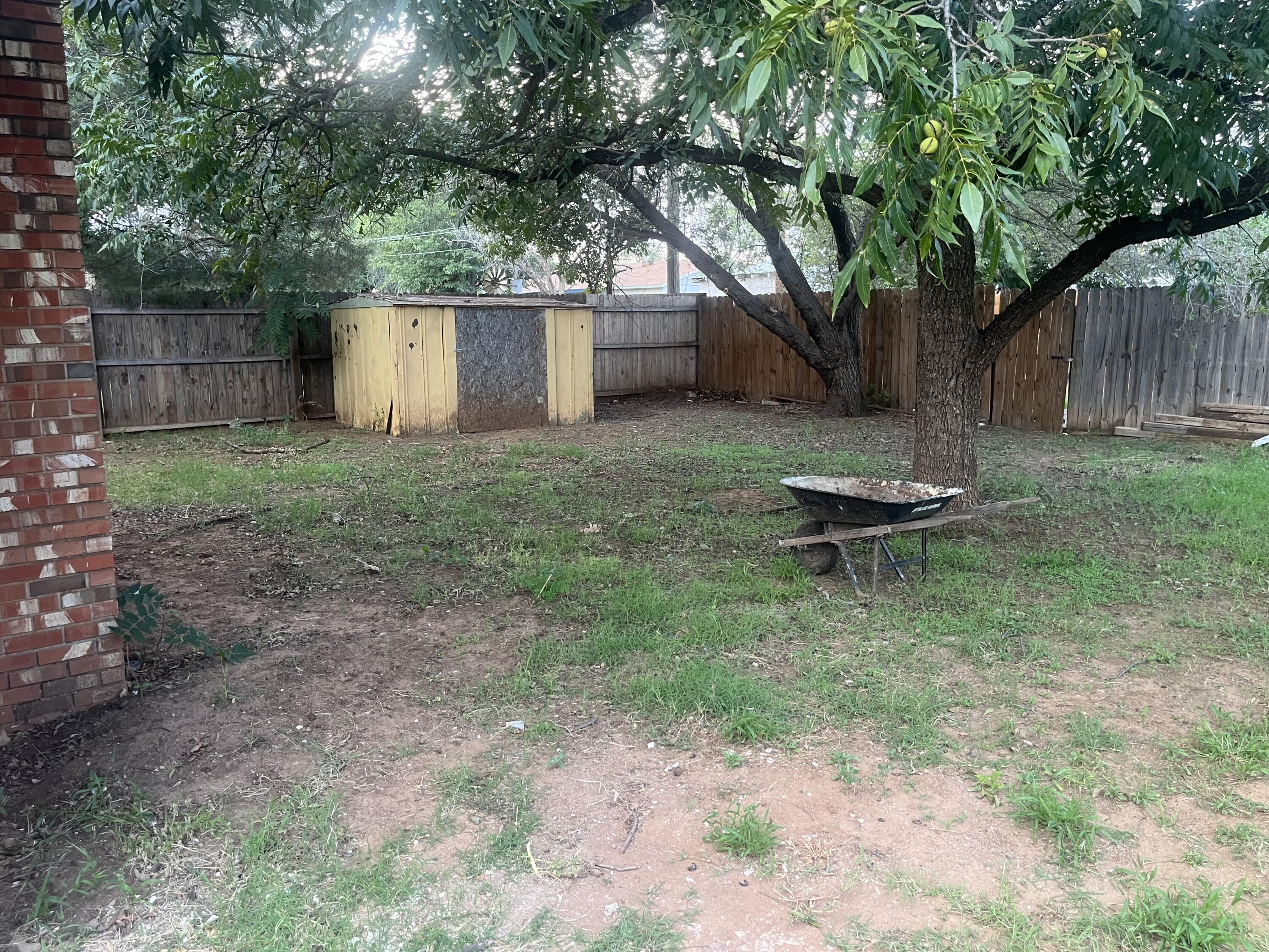 1906 70th Street Lubbock, TX 79412 - Photo 25 of 27 a backyard of a house with table and chairs
