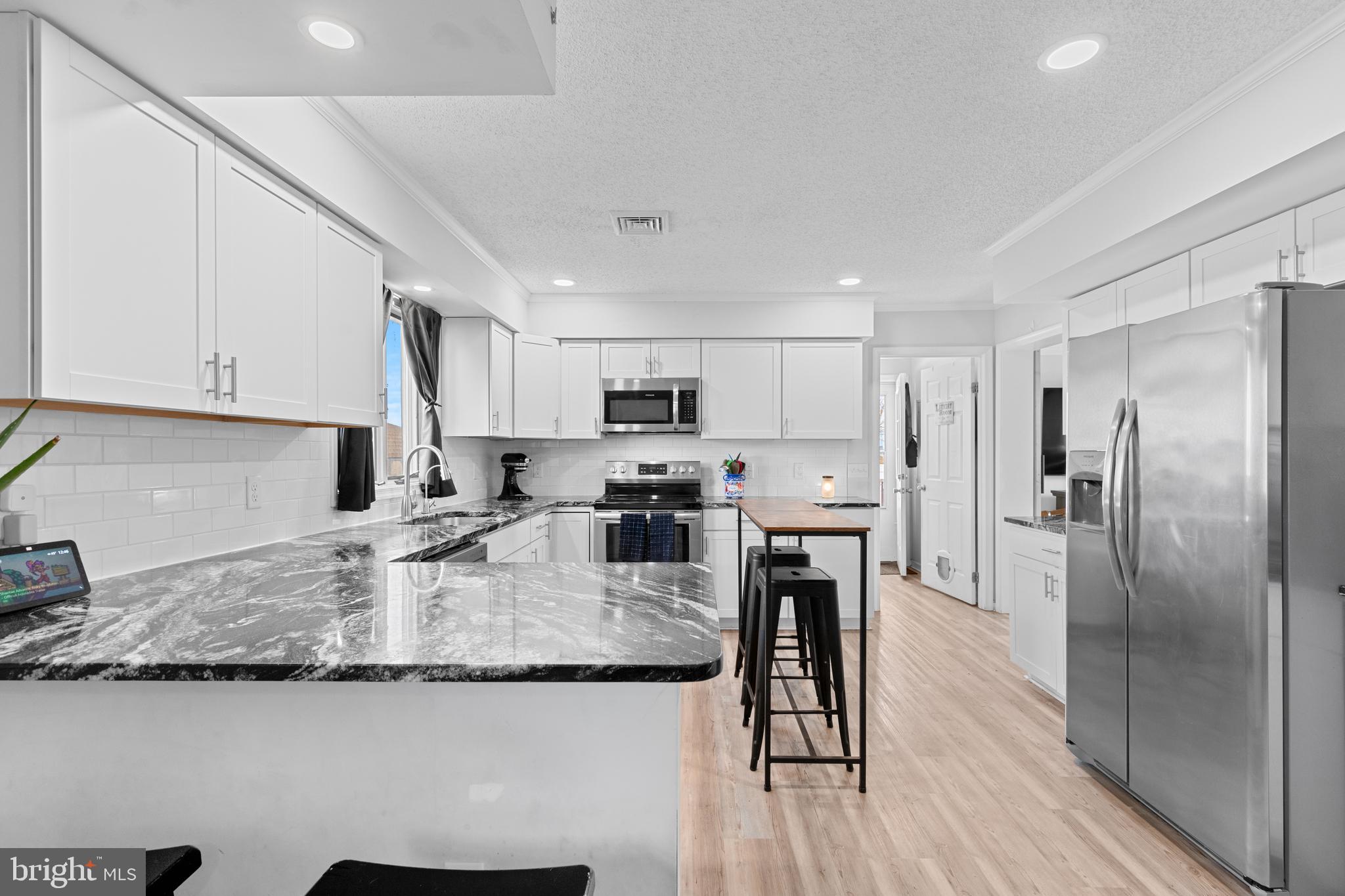 13171 Shiloh Church Road Laurel, DE 19956 - Photo 13 of 42 a kitchen with kitchen island granite countertop a sink cabinets and stainless steel appliances