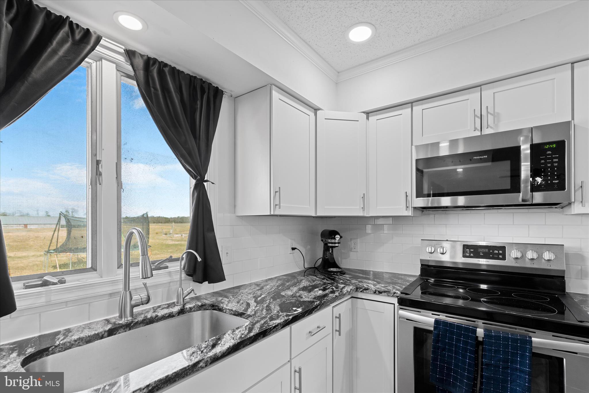13171 Shiloh Church Road Laurel, DE 19956 - Photo 16 of 42 a kitchen with stainless steel appliances granite countertop a sink a stove and a microwave