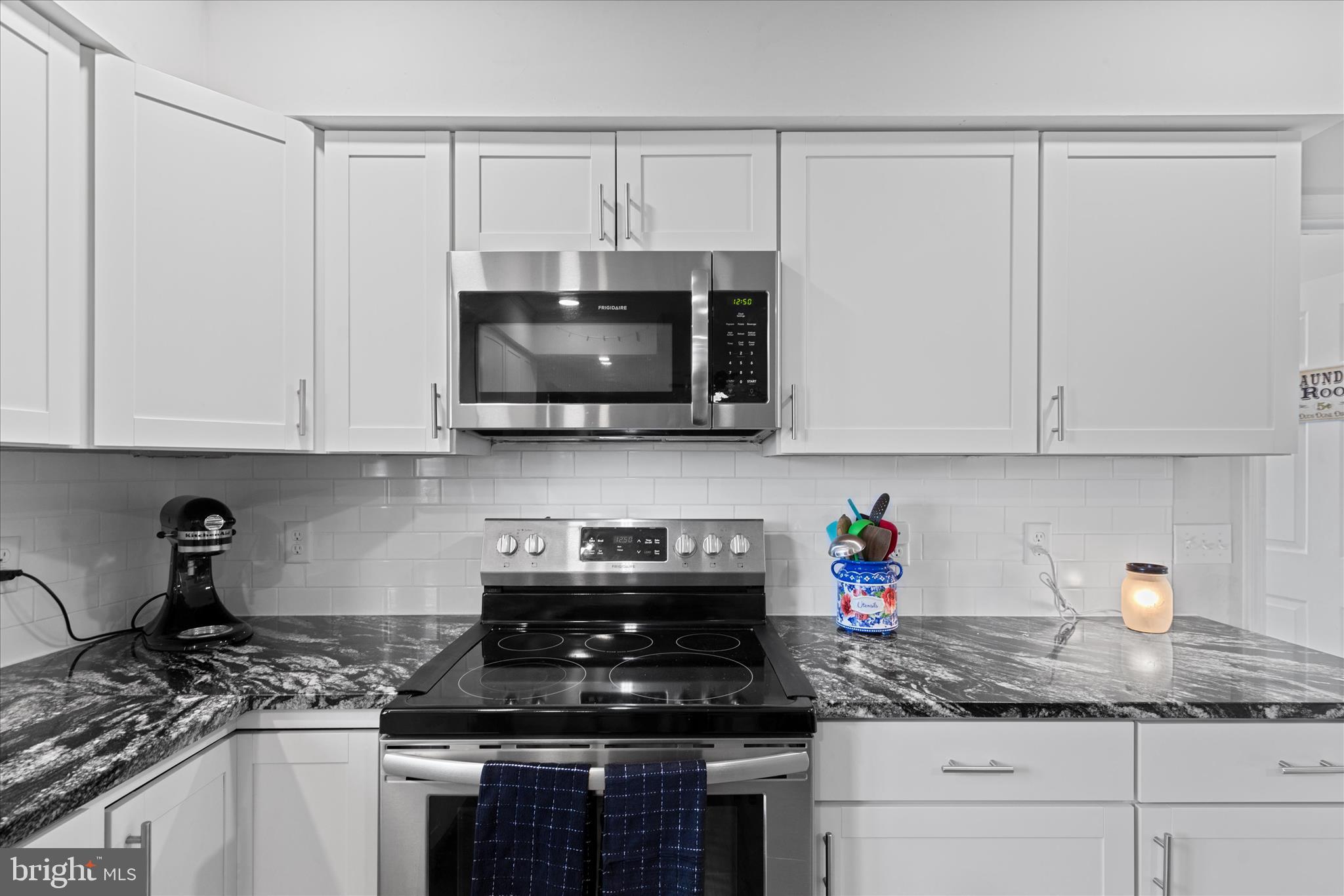 13171 Shiloh Church Road Laurel, DE 19956 - Photo 17 of 42 a kitchen with stainless steel appliances granite countertop white cabinets granite counter tops and a wooden floors