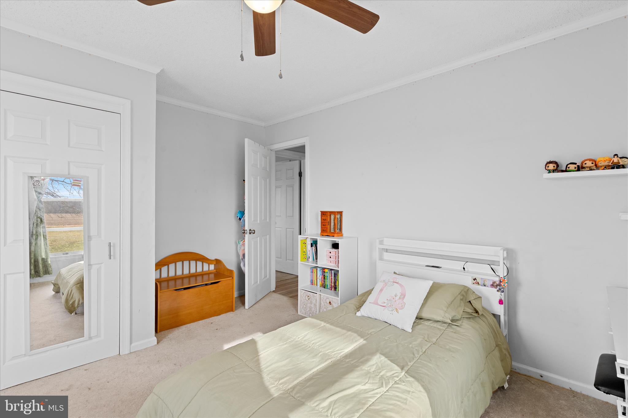 13171 Shiloh Church Road Laurel, DE 19956 - Photo 35 of 42 a bedroom with a bed and a chandelier