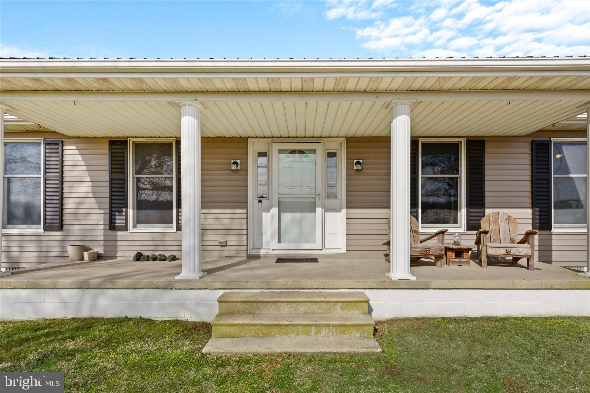 13171 Shiloh Church Road Laurel, DE 19956 - Photo 4 of 42 a front view of a house with a sitting area