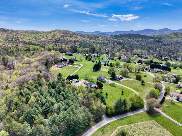 a view of a house with wooden fence