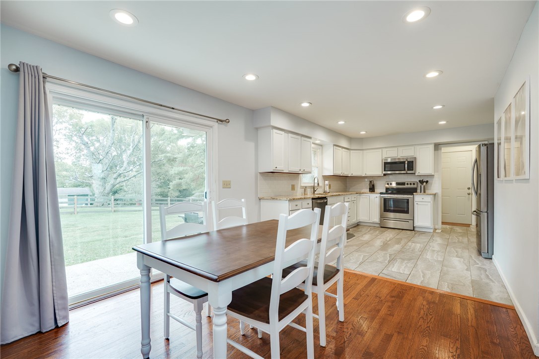 6950 Red Lion 5 Points Road Springboro, OH 45066 - Photo 16 of 78 Bright and inviting kitchen and dining area with seamless outdoor access.